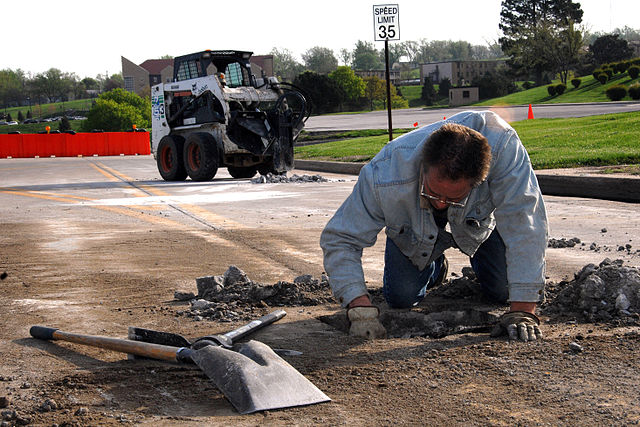 Man fixing pothole, U.S. Air Force Photo By/Josh Plueger [Public domain], via Wikimedia Commons